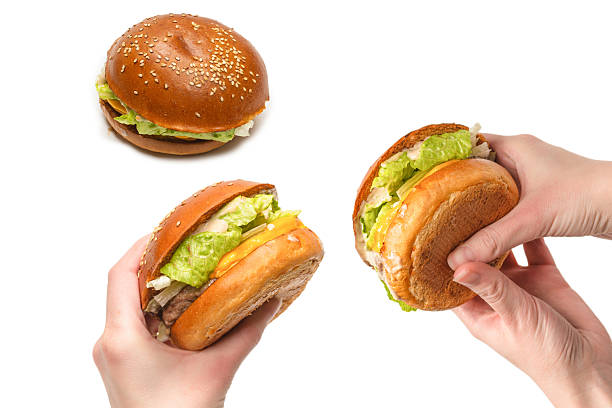 istock Hamburger in woman hands isolated on a white background. 2230824597