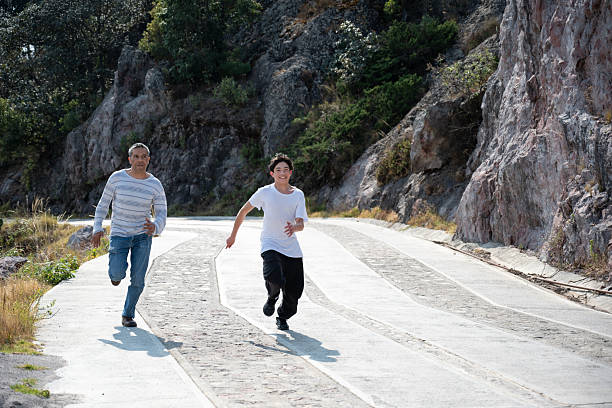 A father with son sport running together outside