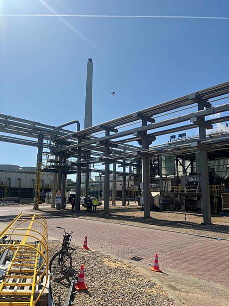 istock Drone flying over industrial site with clear sky. 2230825502
