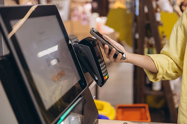 istock Customer Paying Contactless with Smartphone at Supermarket Checkout 2230825846