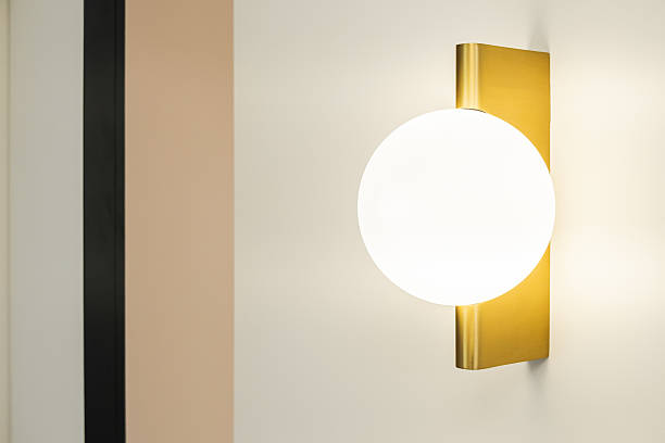 istock Elegant wall sconce illuminates modern interior in neutral color scheme 2230826959