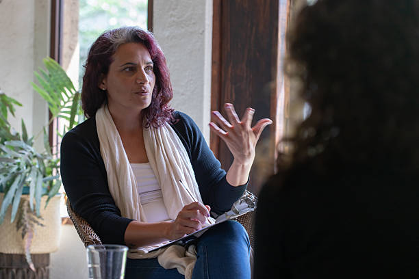 istock Hispanic woman speaking to patient in therapy or coaching session 2230827528