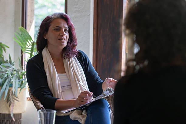 istock Hispanic woman speaking to patient in therapy or coaching session 2230827529