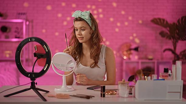 istock Engaging Beauty Enthusiast in Vibrant Home Makeup Setup 2230827740