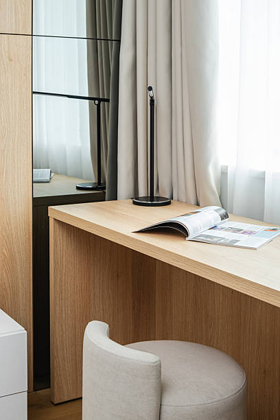 istock Minimalist workspace in modern home with natural light and soft textures, featuring wooden desk and stylish lamp for productive environment 2230828508