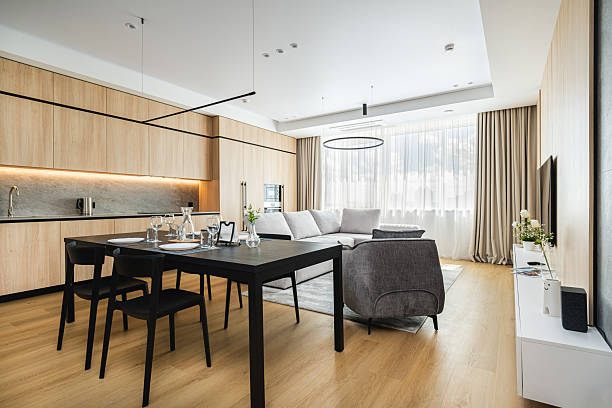 istock Modern living space features open floor plan with dining area and cozy seating in bright, stylish interior design 2230828902