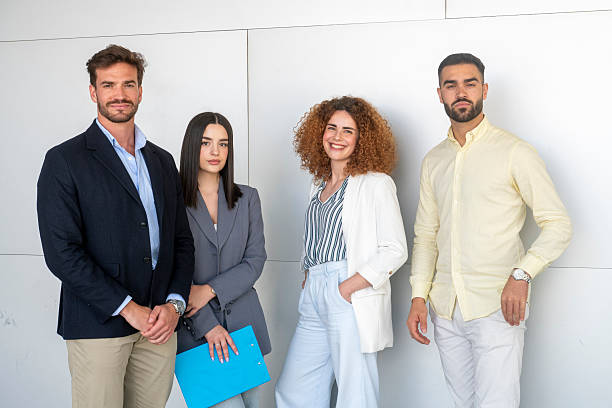 istock Four business colleagues smiling together in modern office 2230829593