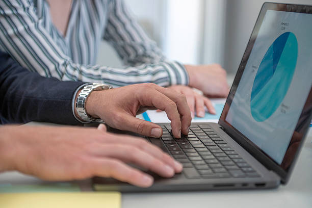 istock Business team analyzing data on laptop in office meeting 2230830570