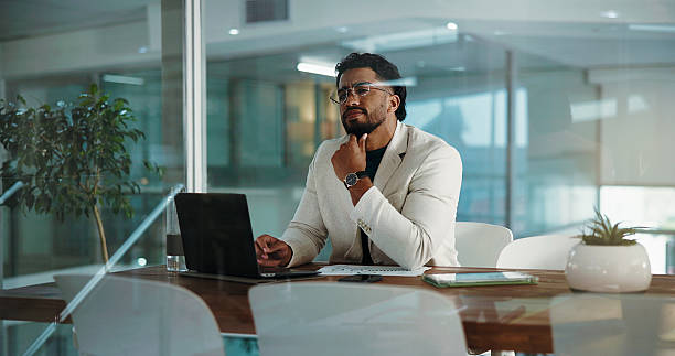 istock Business, thinking and man in office, laptop and problem solving with feedback for audit. Financial agency, employee and person with pc, budget report and confused with decision, email and solution 2230836203