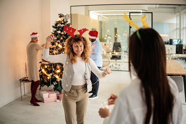 istock Coworkers Collaborating on Christmas Decorations 2230837223