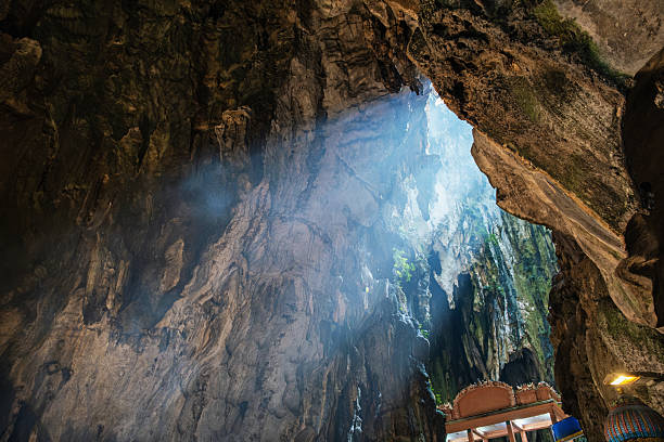 istock Sunlight streaming through Batu cave opening, illuminating the rugged rock formations and casting a mystical glow, creating a serene and mysterious atmosphere, Kuala Lumpur, Malaysia 2230839868