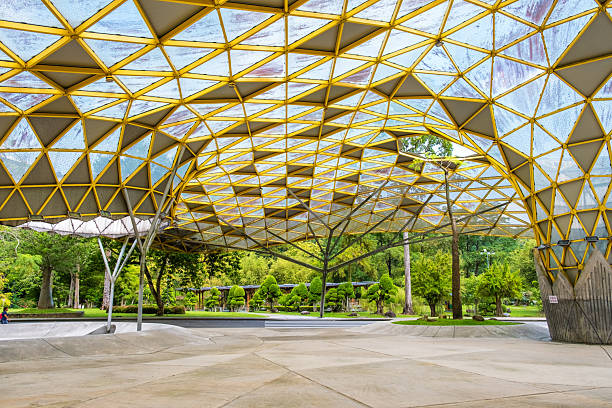 istock Modern architectural structure with yellow geometric roof and large open space surrounded by greenery and trees in Perdana Botanical Garden, Kuala Lumpur, Malaysia, Asia 2230839968
