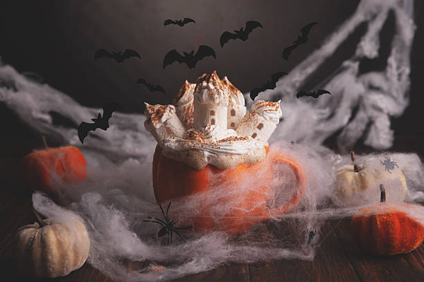 istock Halloween pumpkin latte with a haunted castle topping, bats, and spooky decor. 2230840327