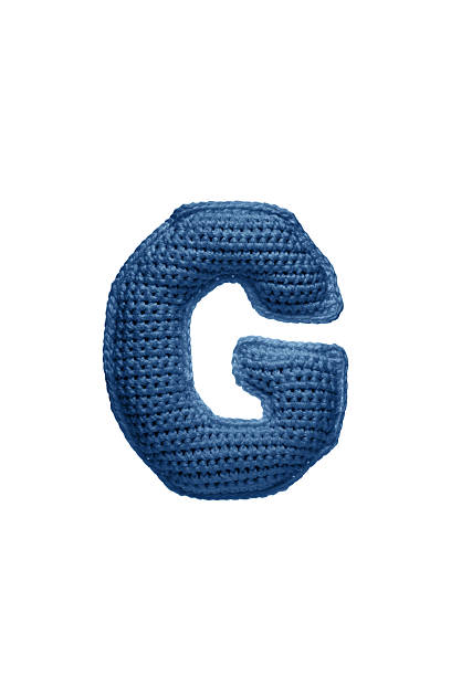 A large letter G, handmade from blue knitted yarn.