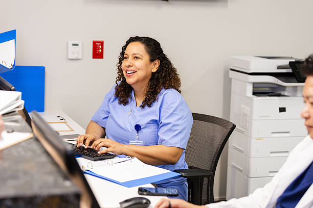 istock Cheerful Healthcare Worker Using Computer in Medical Office 2230845333