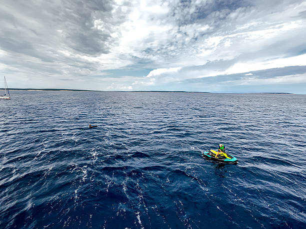 istock Action Shot of Elderly Man Jet Skiing on Wavy Open Water 2230846709