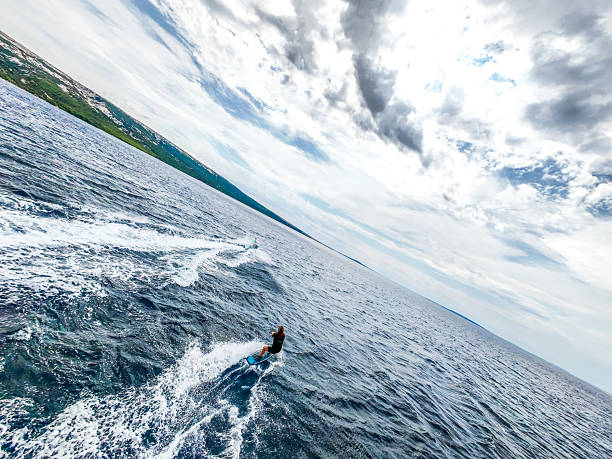 istock Female Athlete Wakeboarding behind Jet-ski in open waters 2230846722