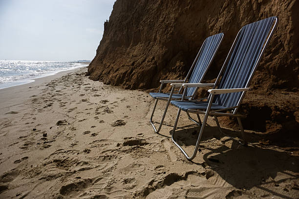 Colorful deckchairs and sun loungers on the beach by the sea