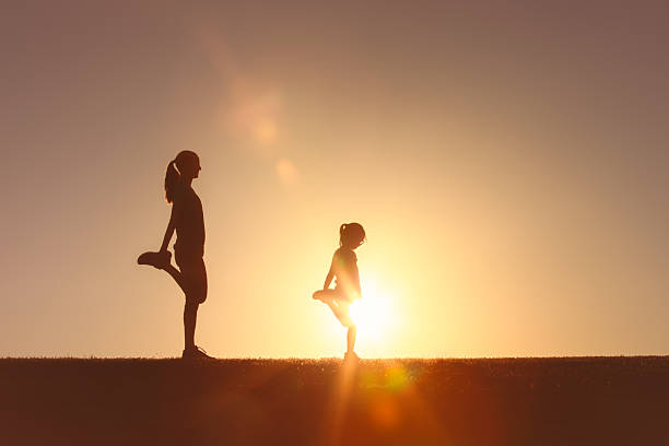 Mother and daughter exercising together.