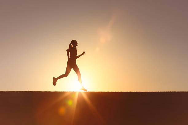 istock Female runner jogging at sunrise. 2230855045