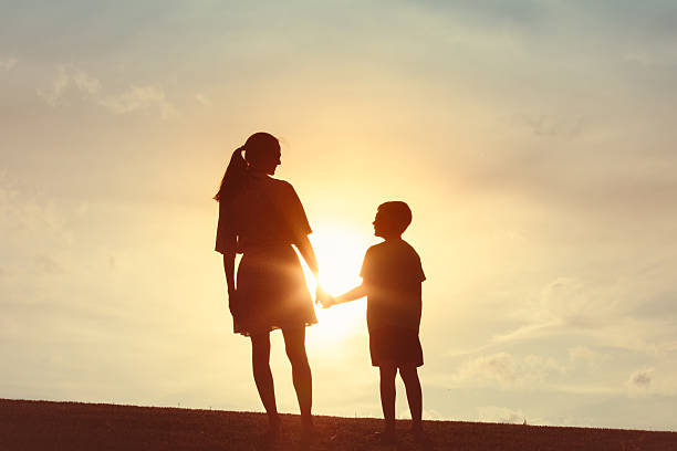 istock Mother and son enjoying each other company outdoors at sunset. 2230855177