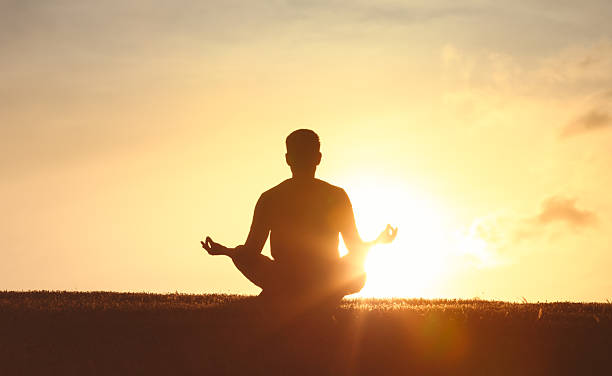 istock Men meditating in the park at sunset. 2230855215