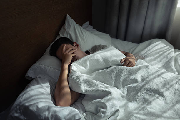 istock Sad lonely tired man home alone in bed suffering from insomnia, depression. 2230857423