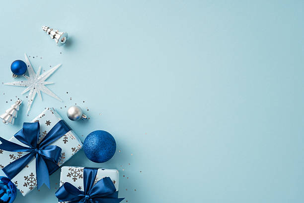 istock Festive Christmas arrangement featuring blue and silver decorations, wrapped gifts with bows, and ornaments on a light backdrop creating a joyful holiday atmosphere 2230861569