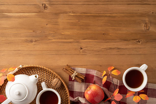 istock Top view of a warm autumn scene featuring tea, apples, and fall decorations 2230861605