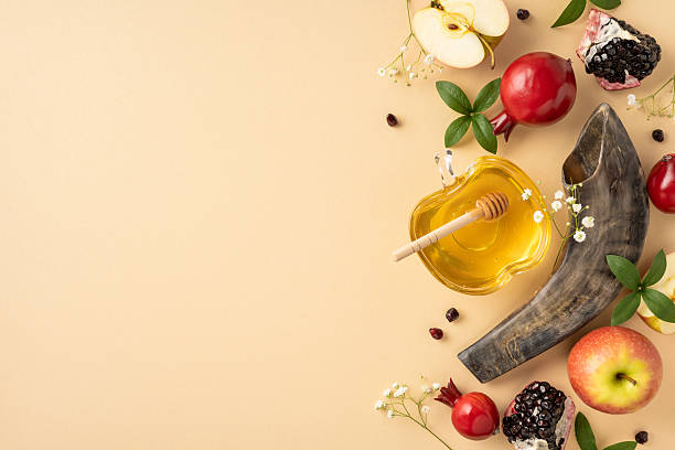 istock Rosh Hashanah items arranged beautifully featuring honey, apples, pomegranates, and a decorative shofar symbolizing blessings for the Jewish New Year 2230861629