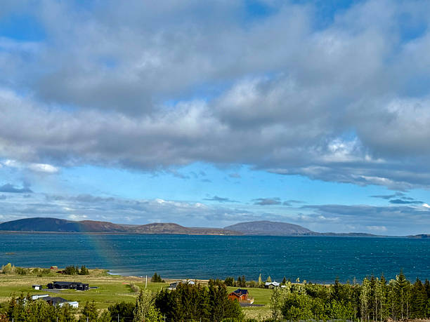 Rainbow forms over the beautiful landscape surrounding Thingvellir Park