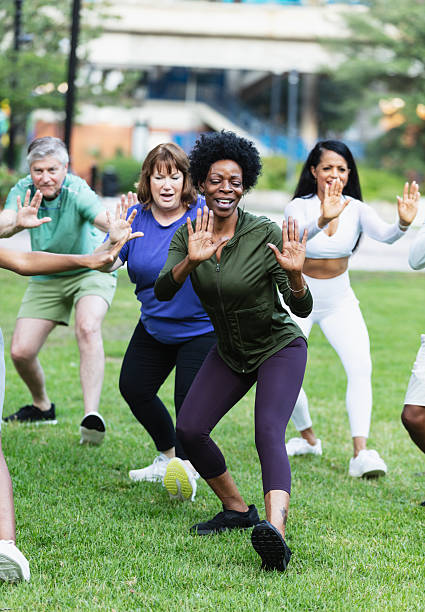 istock Black woman practicing tai chi with group in park 2230863958