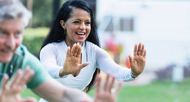 istock Mature Hispanic woman practicing tai chi with class 2230863974