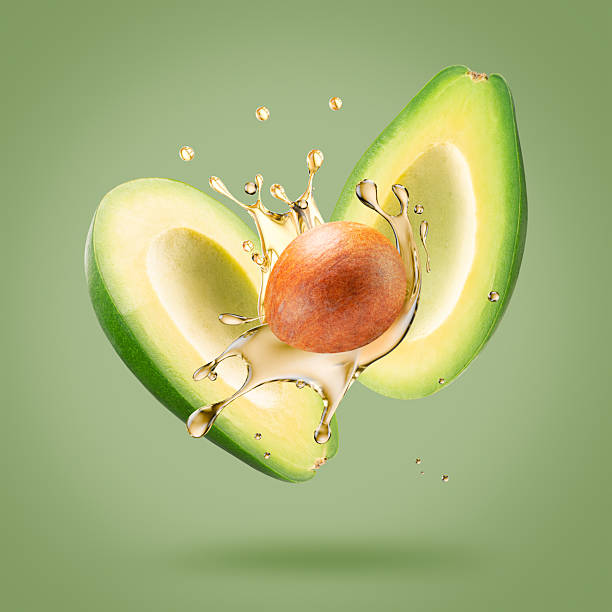 istock avocado with oil splash on a light green background 2230864522