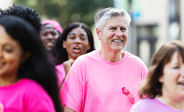 istock Senior man at breast cancer awareness rally 2230865571