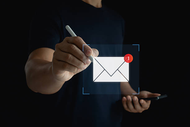 istock Business communication concept with hand holding smartphone and touching email notification icon, digital message alert, new mail symbol, modern technology and online marketing connection. 2230866042