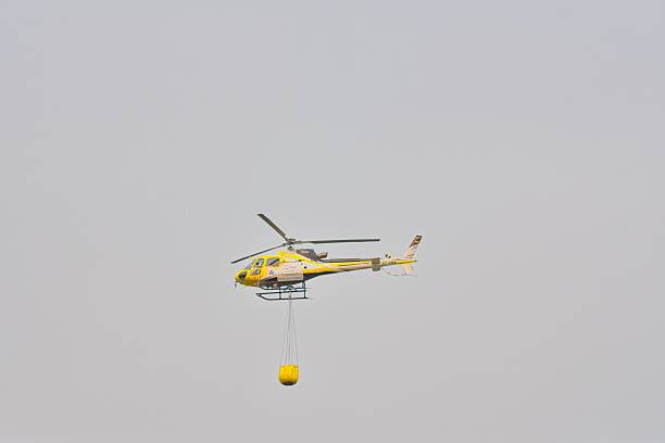 Helicopters fetch water at sea rolled up swirling waves.