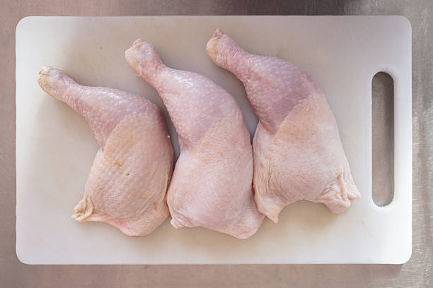 istock Fresh chicken meat and chicken legs lie on a cutting board in the kitchen. 2230867688