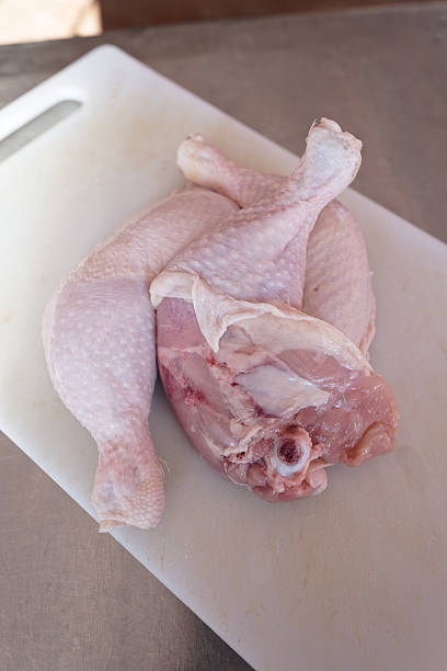 istock Fresh chicken meat and chicken legs lie on a cutting board in the kitchen. 2230867740