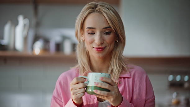 istock Smiling businesswoman drinking coffee taking work break in home office closeup 2230868230