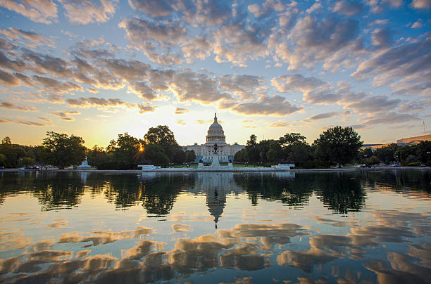 Washington, D.C., USA - October 15, 2022: The US Capitol Building reflected in the pool at sunset on an autumn day.
