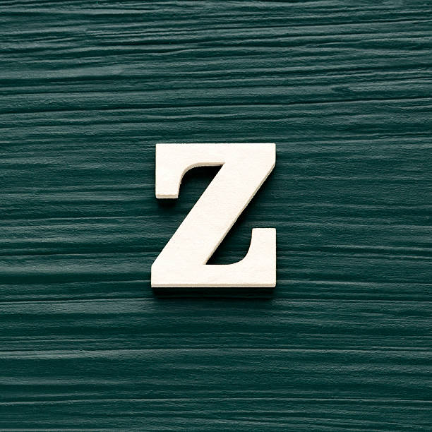 istock Alphabet letter Z, white piece on a dark green rustic background 2230874699