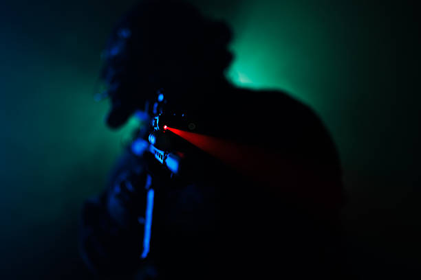istock Silhouette of a tactical figure aiming with laser sight in dramatic lighting 2230874764