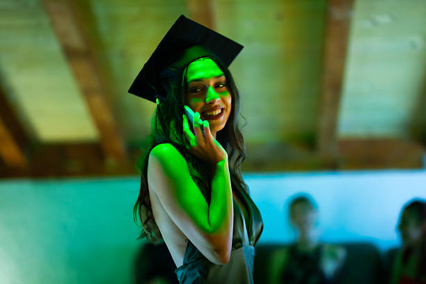 istock Smiling graduate on the phone during a joyous celebration ceremony 2230875067
