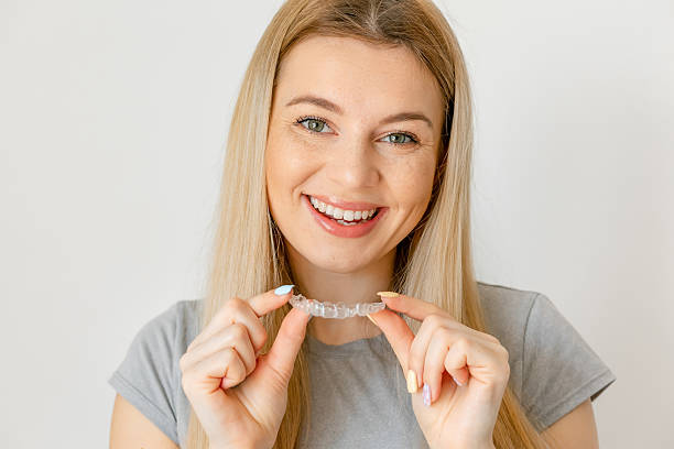 istock Joyful young woman undergoing clear-aligner treatment 2230876175