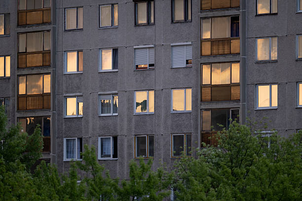 istock Apartment block with glowing windows at sunset 2230876405
