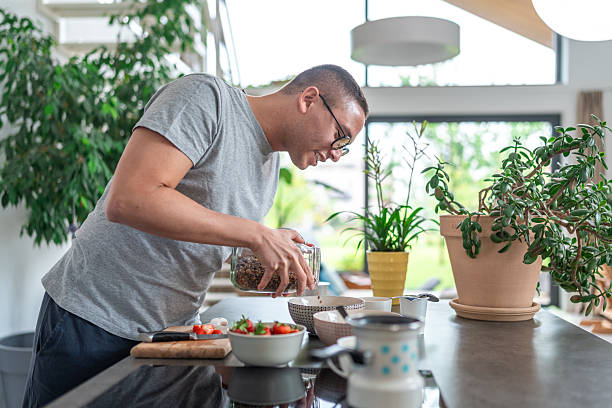 istock Gay Latin Male Cooking in Modern Kitchen 2230882386