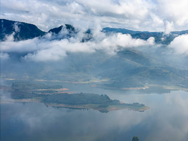 A serene mountain lake scene with mist and clouds, showcasing natural beauty and tranquility. The visual style is calm and atmospheric, ideal for nature-themed projects or relaxation imagery.
