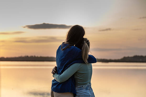 istock Lesbian couple at sunset in nature 2230887794