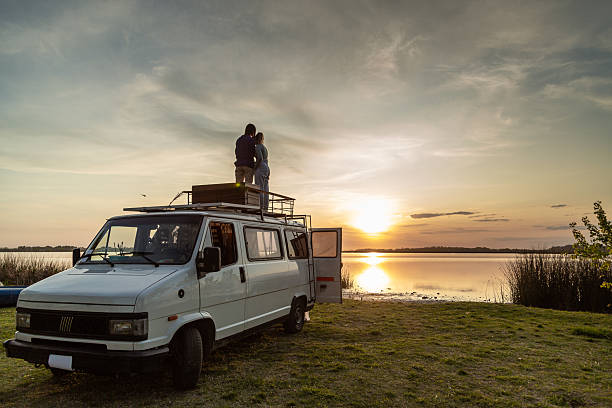 lesbian couple having fun in a motor home in nature at sunset